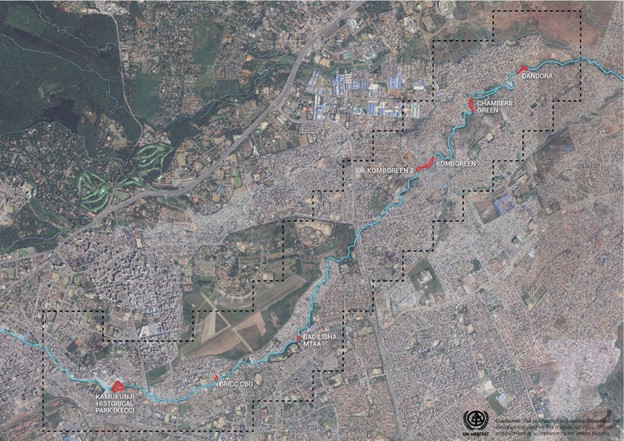 Satellite map showing a river flowing through an urban area with labeled points marking key locations such as Pandora, Chambers Green, Kombretin, Balo Usha Mitra, and Kamukuni Historical Park. The river path is highlighted in blue, with red markers indicating significant sites along its course within a densely built cityscape.